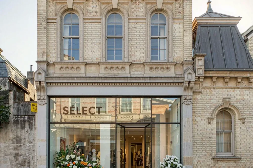 Renovated boutique shopfront with frameless glass and slim black frames in a brick building