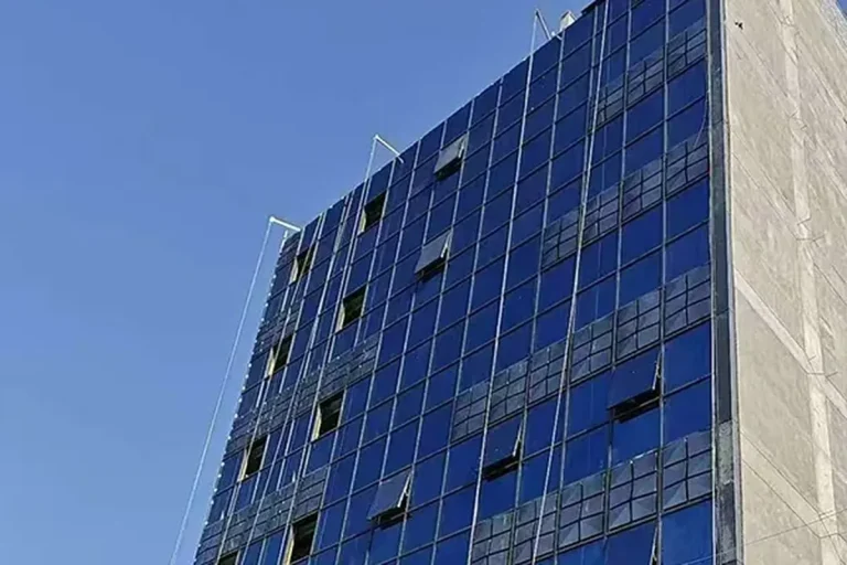 Completed stick curtain wall facade on a three-storey commercial building in Baghdad Iraq, delivered under a single design supply and installation contract