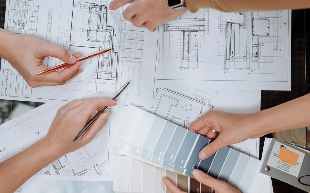 Architectural team coordinating technical drawings and material finishes