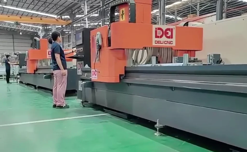 Operator working at a CNC machining centre for aluminium facade profiles