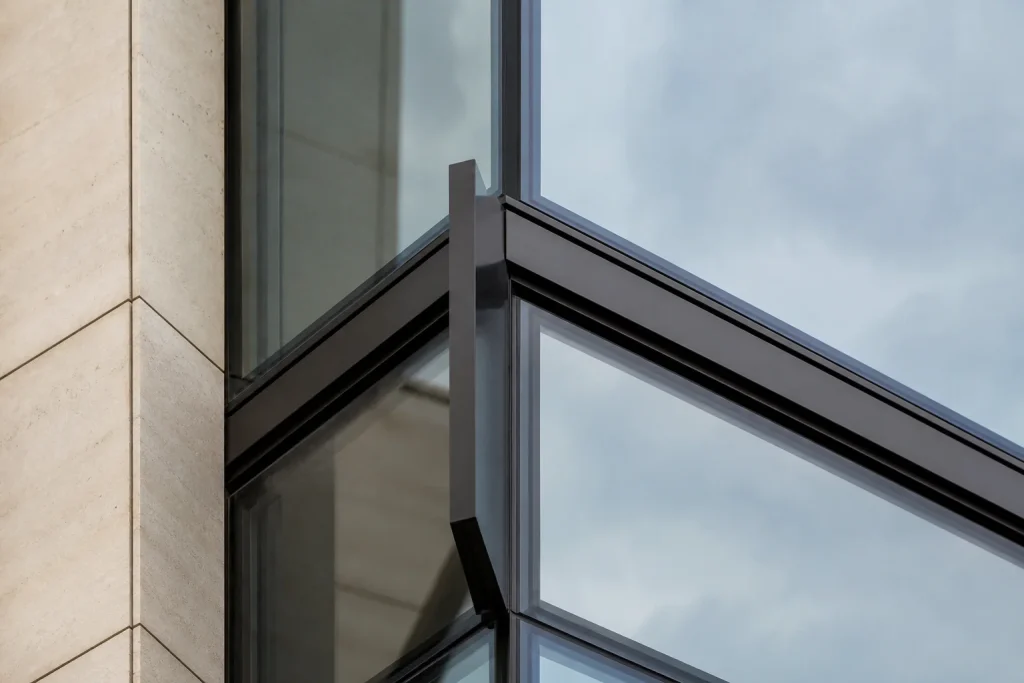 Close detail of a dark aluminium and glass facade corner