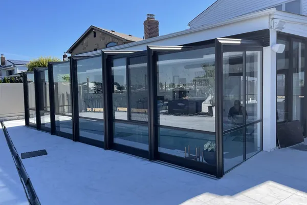 Long Island pool enclosure exterior with marina view