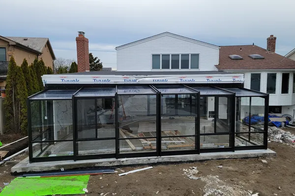 Long Island pool enclosure folding glass wall mid-retraction
