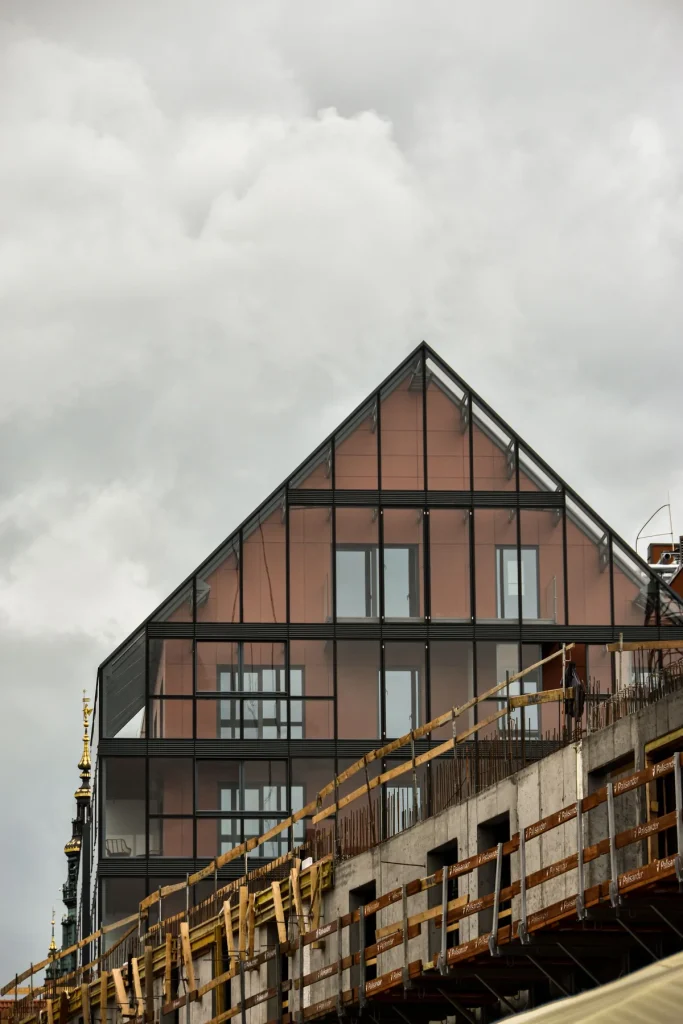 Existing glazed elevation beside an active construction area during site assessment